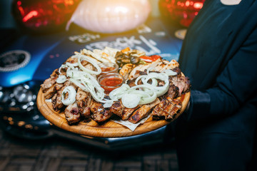 mix meat on a board in a hand for a waiter