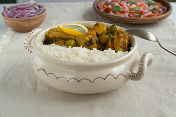 Tajine is a traditional Moroccan dish. Braised chicken in tomato sauce with salted lemon and olives.