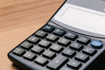 Modern calculator, Business and Finance accounting concept on wooden table