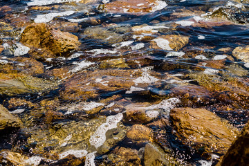 river with a stream and pebbles.pebbles at the bottom of the river