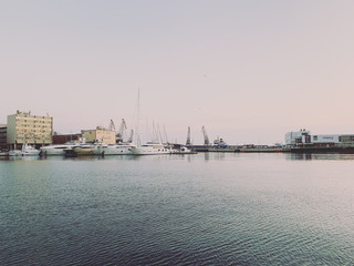 Fototapeta premium Silhouettes of the cranes in the sea port