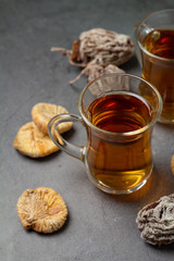 cups of tea and dried fruits from persimmons and figs close-up