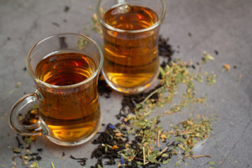 glass cups with tea and tea leaves close up