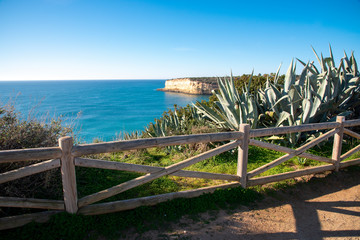 high cliffs and high tide on the shore of the Atlantic Ocean. Portugal. Algarve.