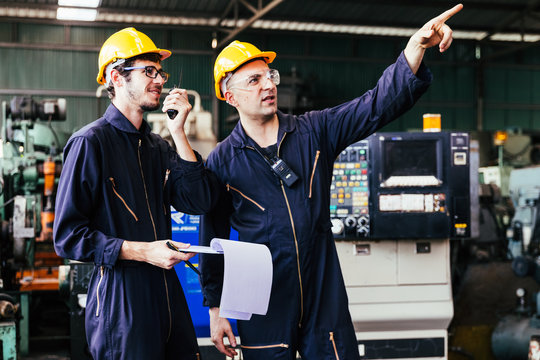 Group of industrial factory maintenance engineers inspect relay protection system using walkie talkie with copy space for your text. Industry, Maintenance, Engineering and construction concept.