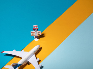Naklejka premium Flat lay design of travel concept with plane and cloud on blue and pink background with copy space. Way directional.