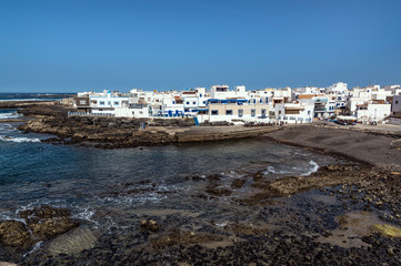 Fototapeta na wymiar Old port and buildings of small town El Cotillo north of Fuerteventura Island, Canary Islands
