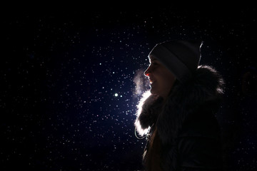 Young smiling woman silhouette. Winter, snow.