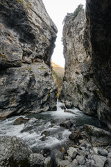 A stormy mountain river flows through a gorge of mountains. Nature.