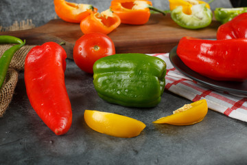 Colorful peppers on a blue stone table.