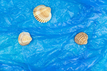 Plastic pollution in ocean concept. Carrier bags in sea shell. Shellfish in bad ecology concept.