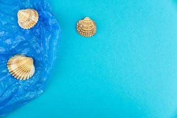 Plastic pollution in ocean concept. Carrier bags in sea shell. Shellfish in bad ecology concept.