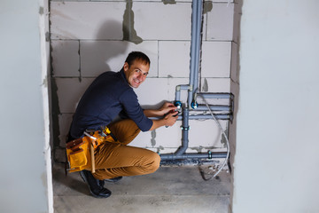 plumber makes wiring of sewer pipes