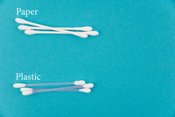 Cotton buds plastic and paper with text on blue background. Concept of Recycling plastic and ecology. Flat lay, top view