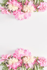 Obraz na płótnie Canvas Wedding concept. beautiful frame of pink peony flowers on a white background. top view, flat lay