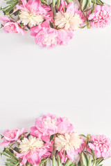 Fototapeta premium Wedding concept. beautiful frame of pink peony flowers on a white background. top view, flat lay