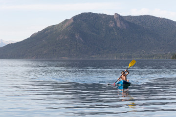 Joven disfrutando las vacaciones de verano en su canoa. 