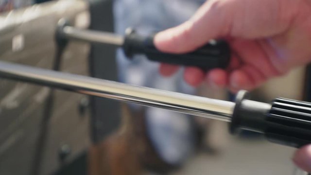 male hands actively move the table football or kicker control knobs