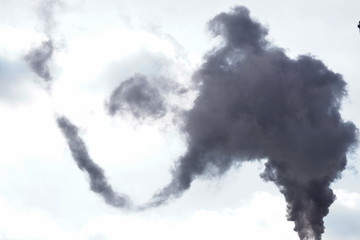 loud of black smoke against blue sky. Industrial city. problem harmful emissions and air pollution of central heating, eco, global warming