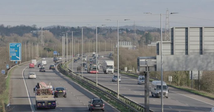 Denham, UK - January 10 2020: Medium shot looking east towards vehicles on the busy M40 near to Denham