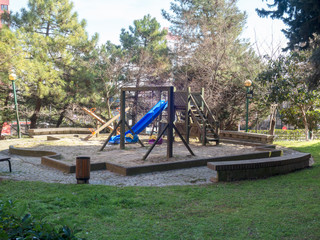 Fototapeta na wymiar Blue and purple swing in the park in nature - Children's Park