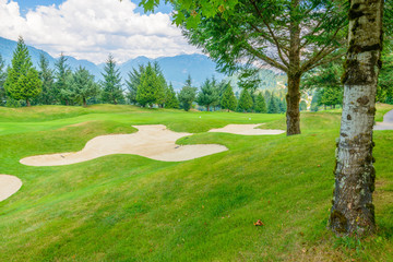 Golf course with gorgeous green and sand bunker