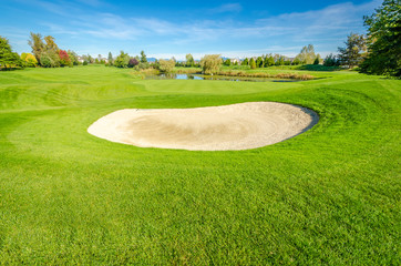 Golf course with gorgeous green and sand bunker