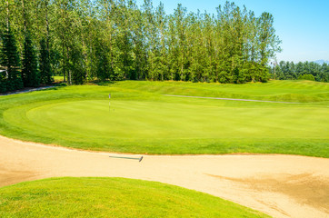 Golf course with gorgeous green and sand bunker