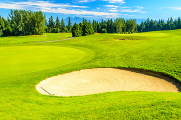 Golf course with gorgeous green and sand bunker