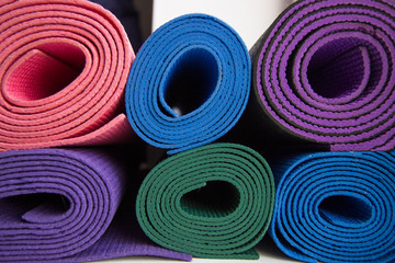 multi-colored yoga mats in the gym