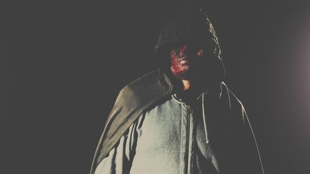Scary killer in mask and hoodie