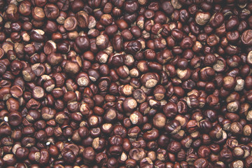 Top view heap of chestnuts. Pile of ripe chestnuts for food background