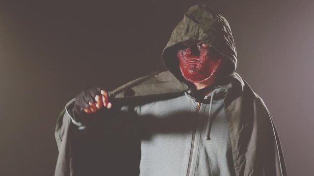 Scary killer in mask and hoodie