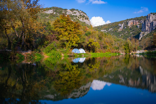 lake in mountains with tents of campers © senerdagasan