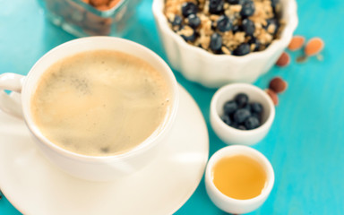 healthy breakfast: oatmeal with blueberries and nuts and coffee with cinnamon and anise