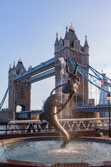 Afternoon view of the tower bridge and the dolphin statue