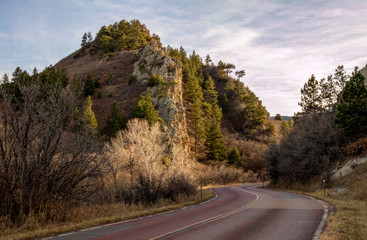 Beautiful red sandstone rock formation near the road in Roxborough State Park, Denver, Colorado, at sunset.
