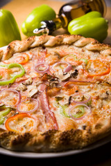 Delicious bright pizza on a dark wooden background,Italian pizza