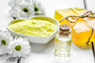 organic cosmetics with camomile extract on wooden table background