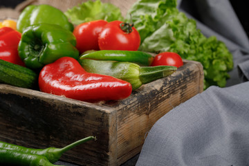 Colorful chili peppers in a rustic wooden tray.