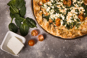 Spinach pizza for vegetarians. Healthy nutrition vegan lifestyle. Delicious pizza which you can eat even on a diet. Only high quality and low fat products like spinach and feta cheese
