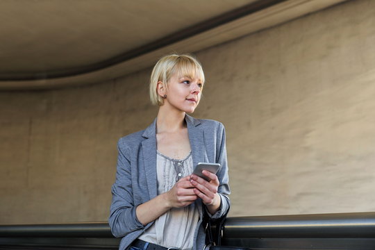 Smiling businesswoman with smartphone
