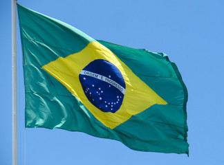 Brazil flag fluttering in the wind. In the center of the flag with the words "order and progress"
