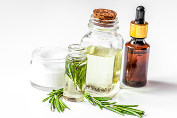 organic cosmetics with extracts of herbs rosemary on white background