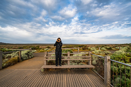 Woman taking a photograph at the Australian bush