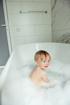 little boy bathing in the foam bath