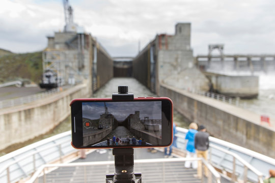A cell phone records a timelapse of a ship going through a lock.