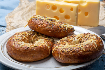 Tasty baked bagels with melted french emmental cheese