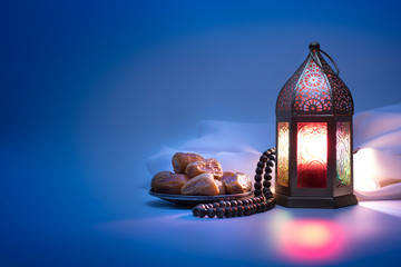 Low light photo of Lantern, Dates fruit and rosary beads for Ramadan and Eid greeting. - obrazy, fototapety, plakaty