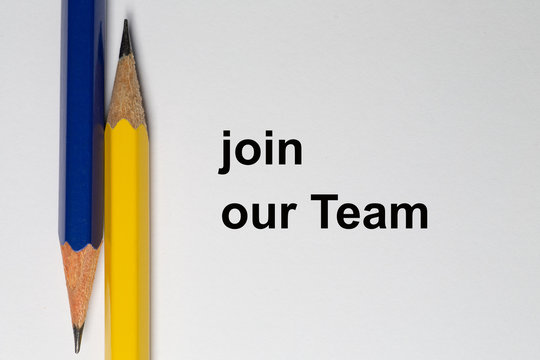 Two sharpened pencils point in opposite directions and are placed vertically on a white background. The solgan join our team is written in black on the background
